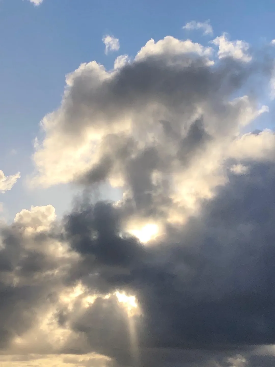Dramatic clouds with sunlight breaking through.